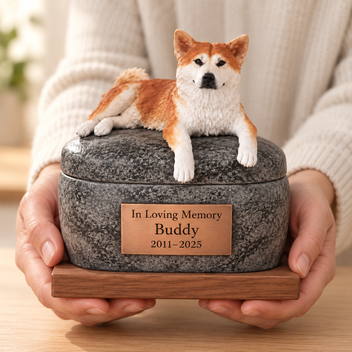 Pet figure keepsake urn, held in two hands for scale